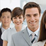 Closeup portrait of happy business group standing together in office